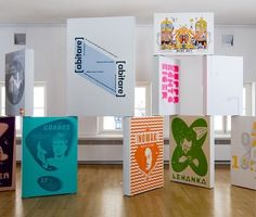 a group of colorful boxes sitting on top of a hard wood floor