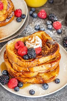 stack of french toast with berries and whipped cream