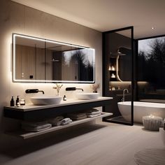 a bathroom with two sinks and a bathtub next to a large mirror on the wall