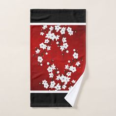 a red and black blanket with white flowers on it