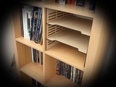 a book shelf filled with lots of different types of dvd's and movies on it