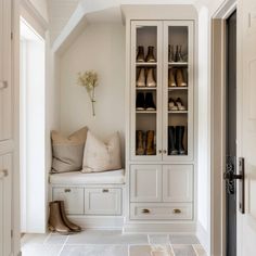 a white closet filled with lots of shoes