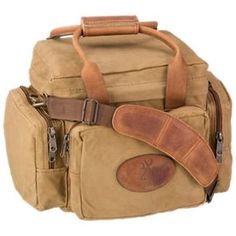 a tan canvas bag with brown leather straps