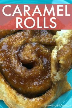 a cinnamon roll on a blue plate with the words caramel rolls in front of it