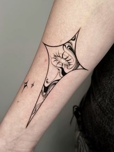 a woman's arm with a black and white tattoo design on the left forearm