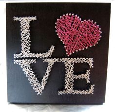 two string art pieces that say i love you and one has a heart on it