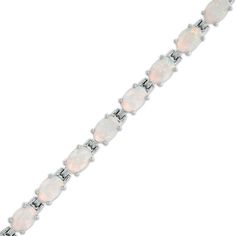 Elevate any attire with ease with this exquisite link bracelet. Crafted in sterling silver, this look showcases a row of 6.0 x 4.0mm oval-shaped iridescent lab-created opal cabochons. Buffed to a brilliant luster, this 7.25-inch bracelet secures with a box clasp. Classic Oval Gemstone Sterling Silver Bracelet, Classic Sterling Silver Bracelet With Oval Gemstone, Classic Sterling Silver Oval Gemstone Bracelet, White Oval Gemstone Bracelet, Box Clasp, Gemstone Bracelets, Sterling Silver Bracelets, Link Bracelets, A Box