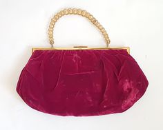 A larger than average burgundy vintage velvet evening bag dating from the 1950's. The bag has a brass tone frame and lift up clasp opening and a solid chain like handle. There is a golden sand coloured lining which has a makers label stamped on it  which reads ' Modell Goldpfeil'.  There are 3 side pockets, one for lipstick and two larger side pockets. plenty of space for mobile phones, keys, make up etc.  Condition: In good vintage condition, The handle is solid, rather than a flexible chain, see video, and two of the links are no longer fixed, meaning the handle  folds on one section, see video. Very useable bag. Some signs of use to the velvet on the bottom right back of the bag. You'll see a few glue like marks here and a tiny hole. See photos Dimensions:  Height: 19cm Frame width: 26c Fifties Style, Fifties Fashion, Photo Dimensions, Burgundy Velvet, Vintage Bag, Vintage Labels, Vintage Velvet, Velvet Bag, Sand Color