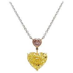 Scarselli is featuring this 6.42 carat heart shaped Fancy Vivid Yellow color diamond and an A 0.51 carat light pink I2 heart shape mounted on a handmade platinum and 18 karats white gold chain necklace (see certificate picture for detailed stones information). A beautiful touch of elegance! Renowned both in New York City and Internationally, Scarselli has the most prominent selection of Natural Fancy Colors. Items are available for viewing by appointment through 1st Dibs messaging Vintage Diamond Necklace, Yellow Diamond Necklace, Colored Diamond Jewelry, Glamorous Jewelry, 1st Dibs, Vintage Pendant Necklace, Heart Necklace Diamond, Rose Pale, Expensive Jewelry