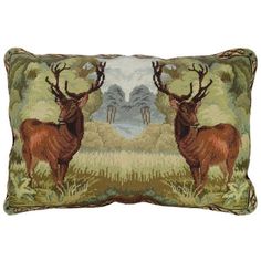 a decorative pillow with two deers on the front and back, both facing each other