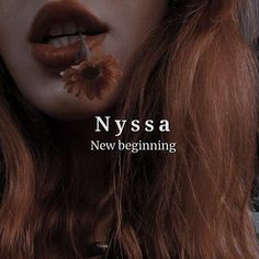 a woman with red hair and makeup has flowers in her mouth as she poses for the cover of nyssa's new beginning magazine