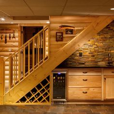 a wine cellar under the stairs in a log cabin