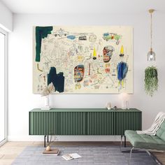 a living room with a large painting on the wall and a green chair in front of it