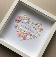 a white frame with buttons arranged in the shape of a heart and saying i love you