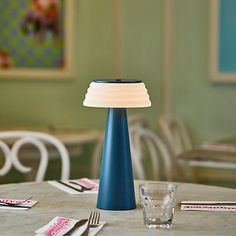 You'll love the convenience of this Blue Metal Cordless Lamp with White Ribbed Shade! It features a cordless design, allowing you to easily move it from room to room. You can even bring it with you to your backyard or on camping trips thanks to its extra protection against the elements! Lamp measures 12.5H in. Crafted of metal Blue finish Tapered body Plastic ribbed shade in white Shade measures 2.5H x 6.5 in. in diameter at widest Touch activated with three (3) dimming modes Features an integrated, rechargeable 1.5-watt LED bulb; bulb is included Cordless design IPx4 rated; safe for outdoor use Care: Dust with a soft, dry cloth. This item is available at Kirklands.com only, not available in stores. Please note: this item cannot be shipped to APO/FPO addresses. | Metal Cordless Lamp with W Cordless Lamp, Cordless Lamps, Move It, Camping Trips, Led Bulb, Table Lamp, Shades, Led, Blue