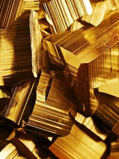 gold foiled objects are scattered together on the floor in this close - up photo