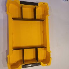 an open yellow plastic box on the wall