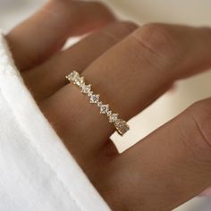 a woman's hand with a diamond ring on it