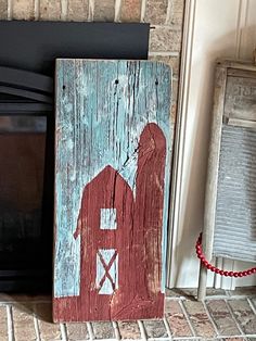 a red barn sitting on top of a shelf next to a black microwave and oven