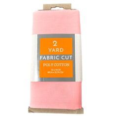 two yards of fabric in pink and white packaging