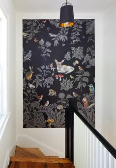 the wallpaper is black and has birds on it