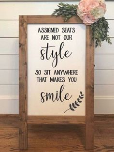 a wooden sign with flowers on it that says, assigned seats are not our style so sit anywhere that makes you smile