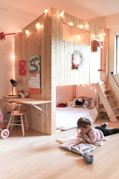 a bedroom with bunk beds and lights on the wall, next to a staircase leading up to a loft bed