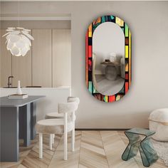 a mirror that is on the wall above a table in a room with chairs and tables