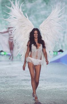 a model walks down the runway in an angel costume