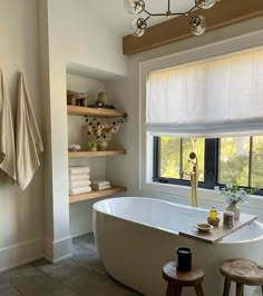 a white bath tub sitting next to a window