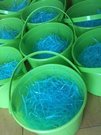 green buckets filled with blue shredded grass