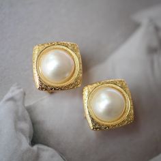 These stunning gold plated silver earrings feature a beautiful pair of hemisphere mabe pearl stones. With their intricate details and rich color, these push back studs are the perfect statement piece for any outfit. Handcrafted with care, these earrings are a true work of art and are sure to draw attention wherever you go. Whether you're looking for a unique gift or simply want to treat yourself. With their durable construction and timeless design, they're sure to become a beloved addition to yo Classic Clip-on Hoop Earrings As Gift, Timeless Gold Round Pearl Earrings, Elegant Gold Clip-on Earrings As Gift, Timeless Gold Earrings For Anniversary, Classic Yellow Gold Bridal Earrings With Elegant Design, Gold Plated Tarnish Resistant Pearl Earrings, Classic Plated Hoop Earrings For Anniversary, Gold-plated Tarnish-resistant Pearl Earrings, Timeless Gold-plated Hoop Earrings For Weddings