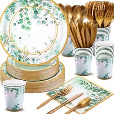 a table set with gold and green plates, silverware, napkins and cups