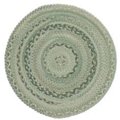 a round rug with green and white colors