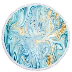 a round beach towel with blue and gold swirls