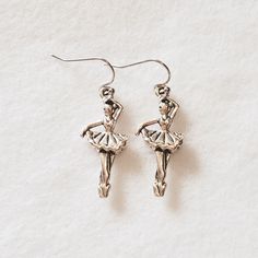 These earrings will make a wonderful gift for that special person in your life or a treat for yourself. Earrings Include:             Ballerina Charm - approx. 1/2" W x 1 1/4" L Stainless Steel Ear Wires/Rubber Backs All charms are made of lead-free, nickel-free antique silver zinc alloy. All orders come in a gift box. Please be sure to read size in the description.      Please message me with any questions. Thank you for looking. Ballet Earrings, Ballerina Earrings, Ballet Jewelry, Ballerina Gift, Ballet Gift, Dance Jewelry, Etsy Earrings Dangle, Special Person, Ear Wires