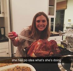 a woman holding a knife over a turkey in a pan on top of a stove