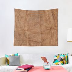 a living room with a couch, coffee table and wall hanging