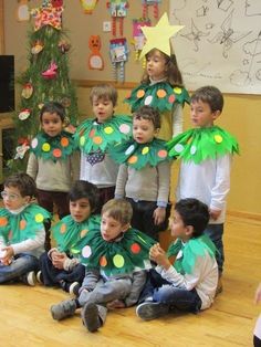 a group of children wearing green christmas tree costumes