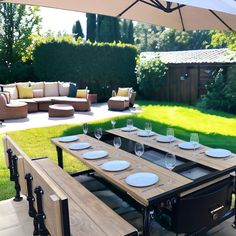 an outdoor dining area with table, chairs and couches set up for two people