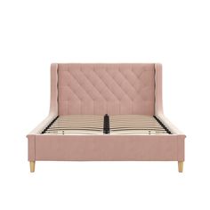 the bed frame is upholstered in pink velvet and has buttons on each side