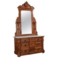 an ornate wooden dresser and mirror with marble top