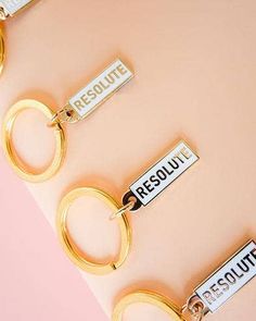 three keychains with the words rescue and result on them sitting next to each other