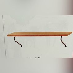 a wooden shelf sitting on top of a white wall