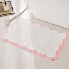 a pink and white bathroom rug with a stethoscope next to it