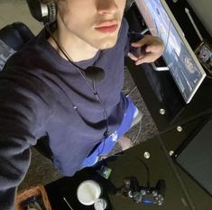 a young man wearing headphones while using a computer