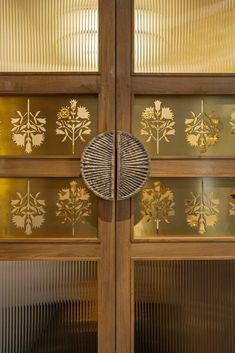 an intricately designed wooden door with glass panels