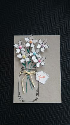 a card with some flowers in a mason jar on it's side and a tag that says goodbye