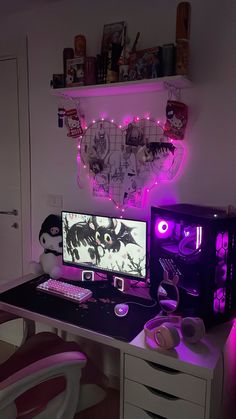 a desk with a computer, keyboard and mouse on it in front of a purple light