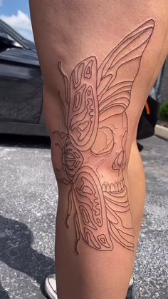 a woman's leg with an intricate tattoo on it